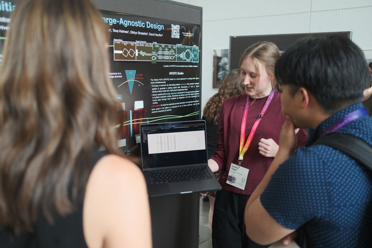 A student showing a cooling-channel simulation at a poster